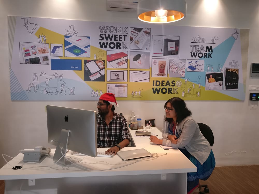 Fun at Dreamscape: a festive desk-side chat under the studio's "work sweet work" wall